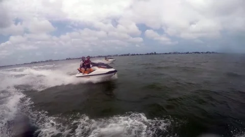 Couple on a wave runner speed past Stock Footage 266858565