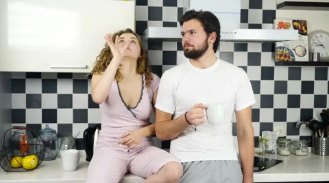 Couple wearing pyjamas having breakfast in the kitchen slow motion Stock Footage 59190930