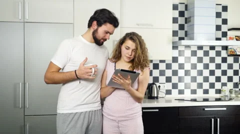 Couple wearing pyjamas using tablet at home slow motion Video stock 59190342