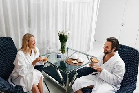 Couple while romantic weekend. Loving young couple in white bathrobes spendin Foto stock
