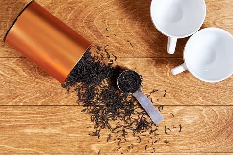A couple of white cups and rustic black tea brew on the wooden breakfast table Stock Photos