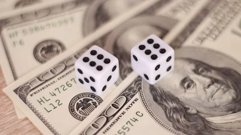 Couple of white dice on dollar banknotes 動画素材 98480376