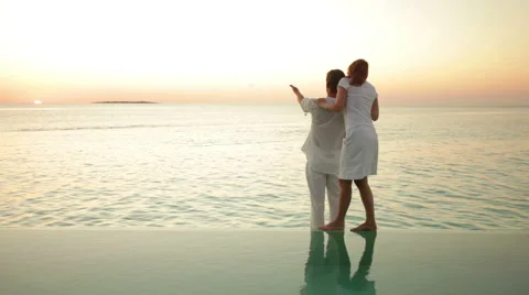 Couple in white at private pool Stock Footage 1018254