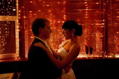 Couple by the window with lights Stock Photos