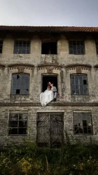 A couple in the window of an old building Stock Photos