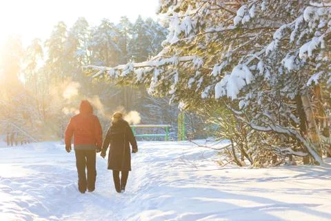 Couple on winter path in forest Stock Photos