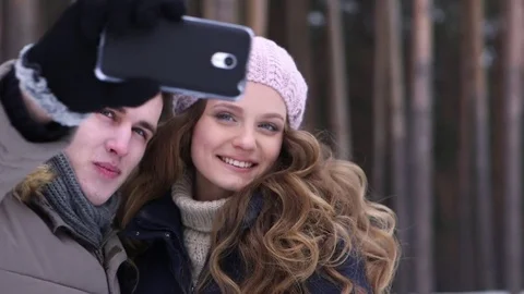 Couple Winter Snow Forest Walk Man And Woman Taking Selfie Photo Smart Phone Vídeos de archivo 70990009