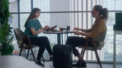 Couple working and waiting for flight at airport lounge 库存影片 334567463