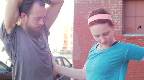 A couple working out and stretching together in an urban environment. Video stock 67981185