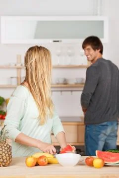 Couple working together in the kitchen Stock Photos