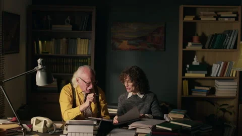 Couple of Writers Discussing Manuscript in Study Stock Footage 312156850
