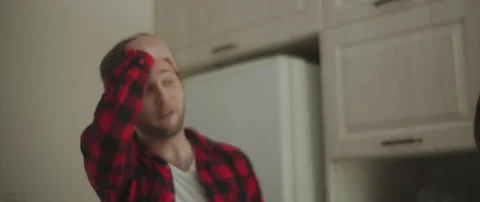 Couple yelling at each other while having a big fight in the kitchen Stock Footage 132365327