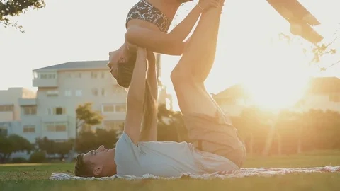 Couple yoga in the park Stock Footage 76521607