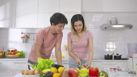 Couple young asian preparing vegetarians drinking fresh smoothie and smile enjoy Stock-Footage 147372175