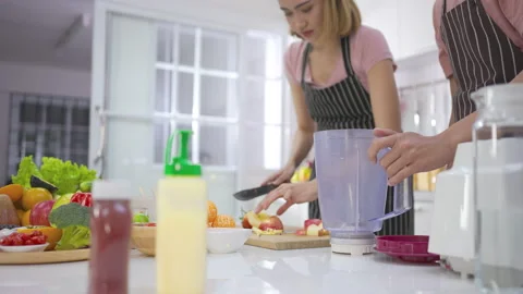 Couple young asian preparing vegetarians drinking fresh smoothie and smile enjoy Stock-Footage 147372629