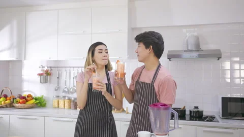 Couple young asian preparing vegetarians drinking fresh smoothie and smile enjoy Stock-Footage 147372671