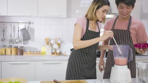 Couple young asian preparing vegetarians drinking fresh smoothie and smile enjoy Stock-Footage 147372698