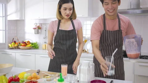 Couple young asian preparing vegetarians drinking fresh smoothie and smile enjoy Stock-Footage 147372908