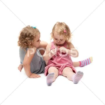 Couple of young little girl sitting over isolated white background Stock Photos