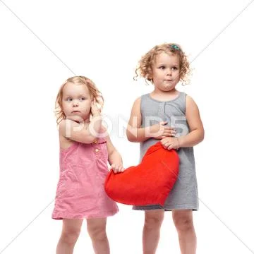 Couple of young little girls standing over isolated white background Stock Photos