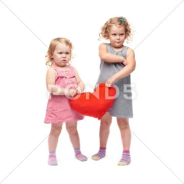 Couple of young little girls standing over isolated white background Stock Photos