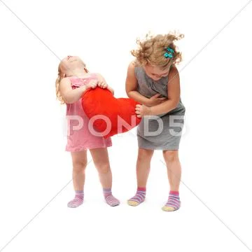 Couple of young little girls standing over isolated white background Stock Photos