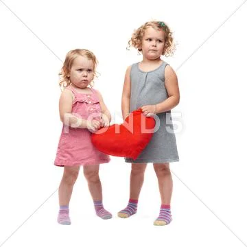 Couple of young little girls standing over isolated white background Stock Photos