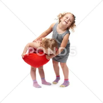Couple of young little girls standing over isolated white background Stock Photos