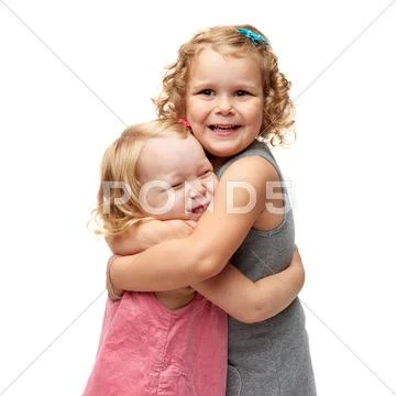 Couple of young little girls standing over isolated white background Stock Photos