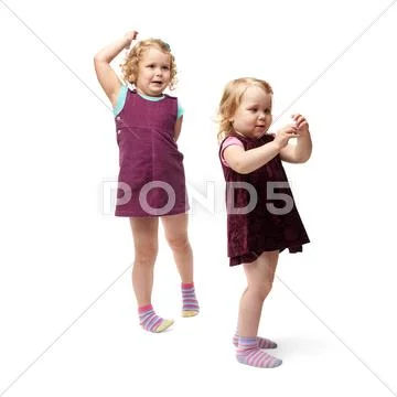Couple young little girls standing over isolated white background Stock Photos