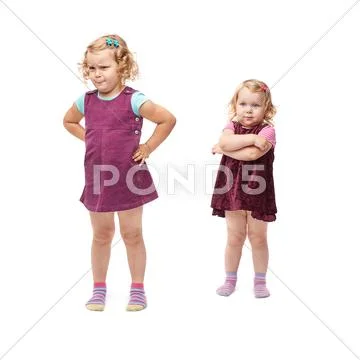 Couple young little girls standing over isolated white background Stock Photos