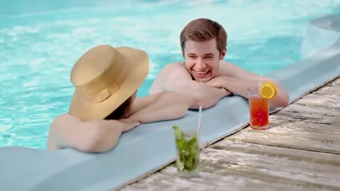 Couple of young lovers having a conversation in swimming pool. Two best Stock Footage 256802443