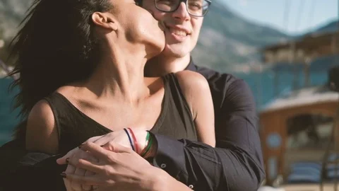 Couple of young people stand hugging on yacht kissing one another Stock Footage 77582953
