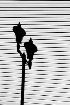 Coupled lamppost shadow Stock Photos