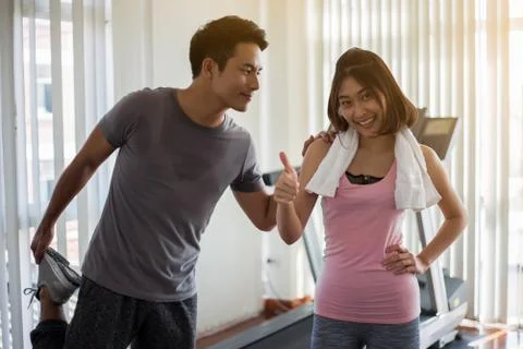 Couples are exercising in the gym. Stock Photos