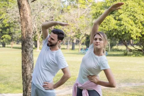 Couples are exercising in the park. Stock Photos