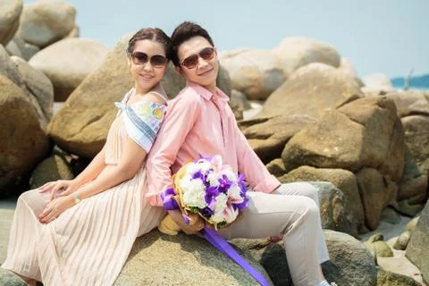 Couples at beach Stock Photos