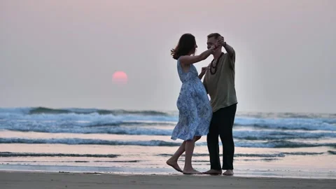 Couples dance at sunset on the shore Stock Footage 263537344