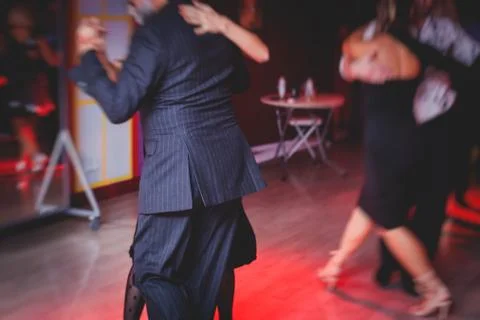 Couples dancing argentinian dance milonga in the ballroom, tango lesson in th Stock Photos