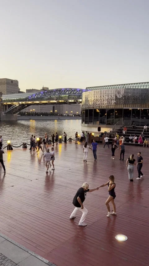 Couples dancing salsa on the Moscow river embankment at sunset Stock Footage 323320540