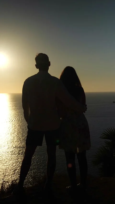 Couples Enjoying Tranquility. Lovers Resting Beside Vast Waters. Two People Find Stock Footage 333798988