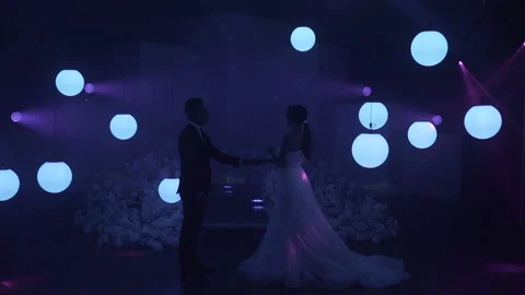 The couples first dance in a wonderful atmosphere, around glowing balls and a Stock Footage 150381391
