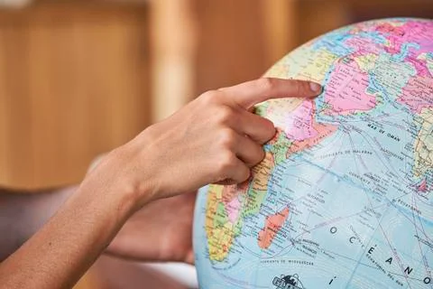 Couple's hands exploring world globe Stock Photos