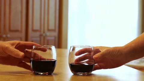 Couples hands make a toast with stemless wine glasses, tumblers. Stock Footage 143521120