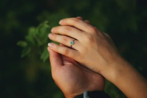 A couple's hands, wedding ring with emerald Stock Photos