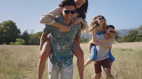 Couples having fun piggyback race Stock Footage 85652401