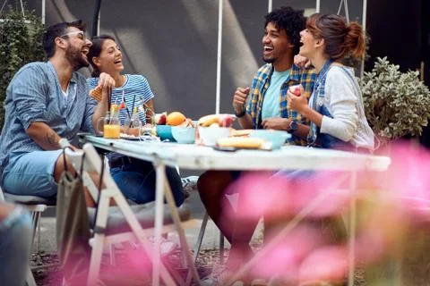 Couples having a good time at the bar's backyard. Quality friendship time tog Stock Photos