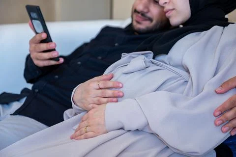 Couples having online call, checking internet about pregnancy in their livi.. Stock Photos