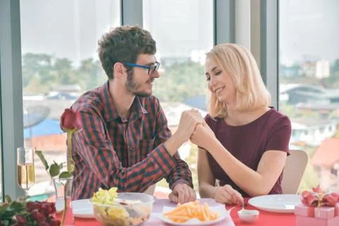 Couples hold hands and propose marriage on the table Stock Photos
