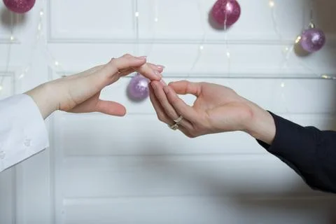 Couples holding hands.a man's hand touches a woman's hand Stock Photos
